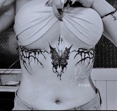 a woman with tattoos on her stomach