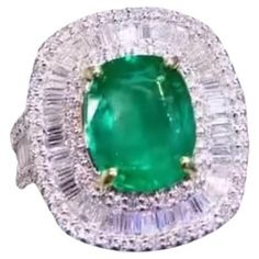 An exclusive cocktail ring, designed with elegance and sophistication, a very refined style. Elevate your look and add a touch of vibrant color and brilliance. Magnificent ring come in 18k yellow gold with a Natural Zambian Emerald , in perfect cushion cut , spectacular vibrant vivid green, fine quality, only Ceo Minor, of 4,60 carats, and 165 pieces of Natural Diamonds in perfect baguettes and round brilliant cut , of 2,30 carats, F-G color VS clarity , very sparkly. Handcrafted by artisan gold Exquisite Green Diamond Ring Luxury, Luxury Emerald-cut Tsavorite Diamond Ring, Luxury Green Diamond Ring, Exquisite Style, Luxury Brilliant Cut Green Gemstones, Luxury Collectible Emerald Cabochon Ring, Gold Cocktail, Zambian Emerald, Gold Cocktail Ring, Zambia