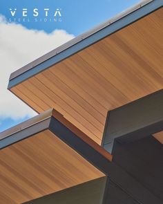 a close up view of the top of a building with wood siding and metal roofing