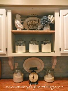 an open cabinet with jars and other items on it