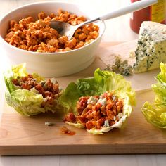 lettuce cups filled with meat and cheese on a cutting board next to other foods