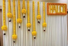 yellow flowers are hanging from the side of a white curtain with orange trimmings