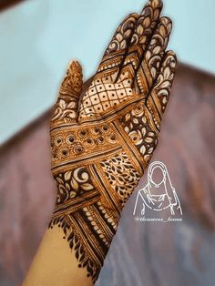 the hand is decorated with intricate designs on it's fingers and palm, as if for mehnish