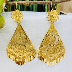 Beautiful and stunning handmade Mexican Filigree Earrings. Each piece is meticulously created out of copper wire and spun into a beautiful design. To give it the final touch artisans dipped into gold plate for it's gold color. This accessory is an important part of the traditional Tehuana outfit from Oaxaca, Mexico. Look elegant while wearing Mexico's culture with this one of a kind earrings! Approximate length: 3.5 - 4 in Artisan Wedding Drop Earrings Jewelry, Traditional Nickel-free Jewelry For Celebration, Bohemian Drop Bridal Earrings For Festivals, Traditional Dangle Flower Earrings For Festivals, Traditional Dangle Flower Earrings For Festive Occasions, Handmade Yellow Gold Bridal Dangle Earrings, Handmade Yellow Gold Dangle Bridal Earrings, Dangle Bridal Earrings For Festivals, Traditional Dangle Flower Earrings For Pierced Ears