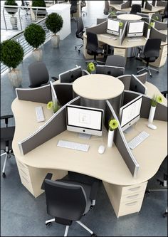 an office cubicle with multiple computers and chairs