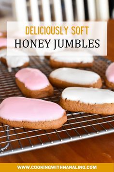 some pink and white frosted cookies on a cooling rack with the words delicious soft honey jumbles