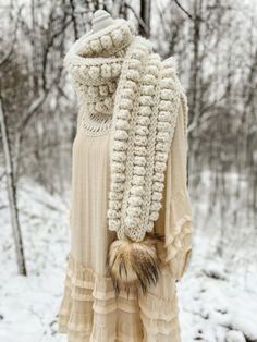 a dress and scarf are on display in the snow