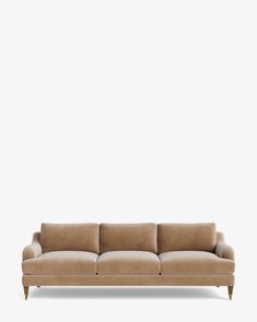 a beige couch against a white wall