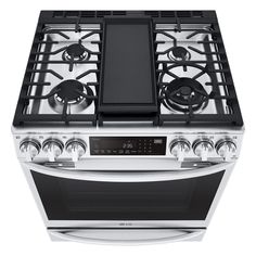 an oven that is built into the side of a white counter top with black burners