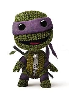 a crocheted teenage mutant holding a microphone