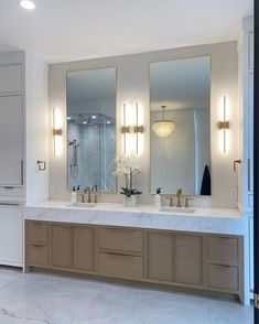 a large bathroom with two sinks and mirrors