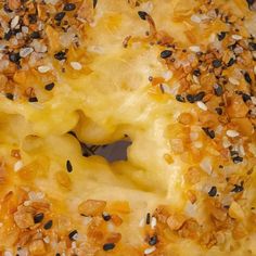 a close up of a doughnut with nuts and other toppings on the top