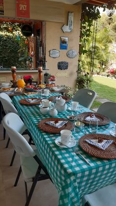 the table is set with plates and cups