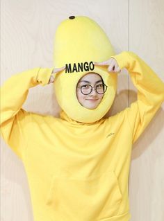 a person wearing a banana costume with the word mango on it's hoodie