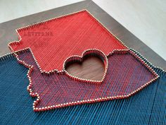 a piece of fabric with a heart shaped hole in the middle on top of it