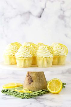 lemon cupcakes with white frosting on a cake stand