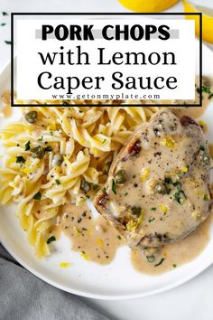 pork chops with lemon caper sauce on a white plate next to some pasta