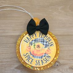 a happy pumpkin spice season ornament with a black bow