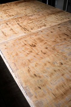 an old wooden table top with no one around it