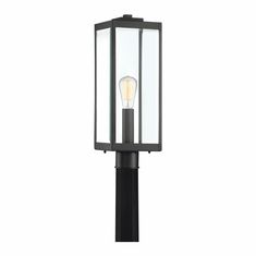 an outdoor post light with a clear glass top and black metal base, on a white background