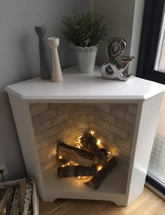 a white fireplace with some lights in it