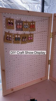 a diy craft show display with lots of earrings