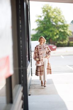 The Cameron coat adds a modern, feminine twist on the elemental bomber. Outfitted in a classic blush Plaid wool, this silhouette features exaggerated bishop sleeves, metal snap buttons, front patch pockets and classic rib trim. The perfect long coat to compliment your autumn ensemble. Our Model Kristi is 5’8 and wearing a XS. She normally wears XS, 26, or 0. Modern Feminine, Denim Jumpsuit, Wool Plaid, Winter Sale, Long Coat, Skirt Pants, Summer Sale, Sweater Top, Jumpsuit Romper