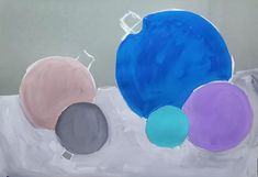 an abstract painting with blue, purple and green circles on white paper in front of a gray wall