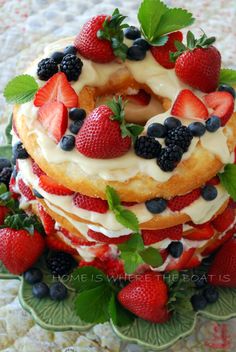 a cake with strawberries and blueberries on top