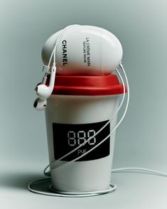 a white cup with headphones attached to it