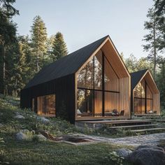 two wooden cabins in the woods with large windows