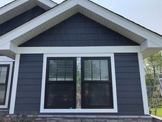 a blue house with white trim and windows