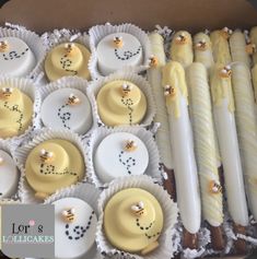 a box filled with lots of yellow and white desserts