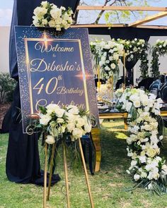 a sign that says welcome to the bride and groom with flowers in front of it