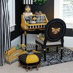 a black and white striped room with yellow accents on the desk, chairs and other decorations