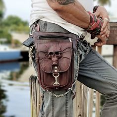 Handcrafted Genuine Vegetal Leather Dark Brown Drop Leg Bag –Skull Design Leather Fanny Pack – Leather Hip Rider Bag We've updated our Unique Drop-leg Bag now. We have put an extra strap to wear as a backpack and it works good. Drop leg bag, Ideal for travel, work, school, hiking, camping, cycling, riding, and other outdoor activities. Adopting one-waist strap and one-leg strap design, the bag can act as a multifunctional toolbag, wallet, purse, first aid kit and so much more. The leg bag has 2 Punk Leather Bag For Festivals, Gothic Skull Bag For Everyday Use, Gothic Brown Bag For Everyday Use, Gothic Brown Bag, Halloween Skull Print Travel Bag, Apocalyptic Accessories, Thigh Bag, Design Backpack, Leather Hip Bag