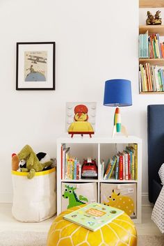 a child's room with bookshelves and toys