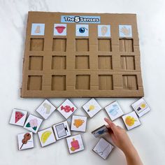 a child's hand is playing with an interactive game that teaches children how to draw and color shapes