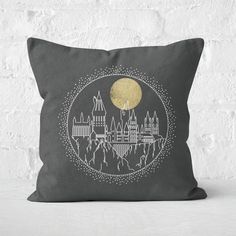 a pillow that has a castle on it with the moon in the sky behind it