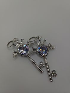 Sparkly heart shape key earrings that look fantastic 👑 Earring hooks are NICKEL FREE 🤍 This item is handmade by me - Please refrain from tugging on the items, be gentle! It may cause breakage for this is handmade. Handle with care! - This item is not waterproof, rusting may occur when wet 🤍About my store - Make sure your address and payment information is valid before purchase. - Once I ship a package it is not in my hands anymore. If something were to happen to your package (ex. lost, or stolen) that is on the shipping provider (ex. usps) - All sales are final, no refunds, returns, or exchanges. - But of course if you have any questions don't hesitate to contact me! - I will ship your item(s) within 3 days. If something comes up and I'm not able to, I will contact you. My local post of Key Earrings, Silver Key, Be Gentle, Earring Hooks, Heart Shape, Heart Shapes, Etsy Earrings, Dangle Drop Earrings, That Look