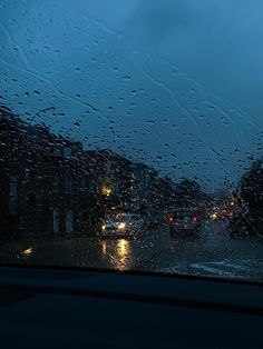 rain is falling on the windshield of a car