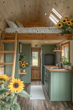 a kitchen and living area in a tiny home with sunflowers on the counter