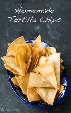 some tortilla chips are in a blue bowl