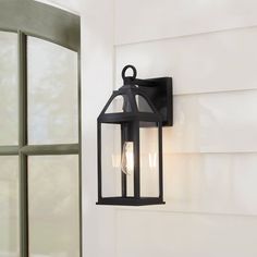 an outdoor light hanging on the side of a house