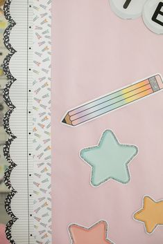 a pink background with stars, pencils and other things on it's side