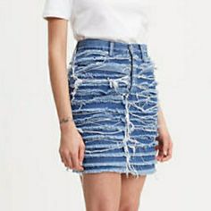 Levis Heritage Sz 24 Layered Fringe Big E Levi's Denim Skirt Crafted From Premium Denim, This High Rise Skirt Flatters Your Shape The Denim Is Washed And Shredded Before Being Bleached To Create A Surreal Texture Layered Fringe Made From Lightweight Denim Style # 677710000 Color: Saddle Up - Medium Wash High Rise Slim Fit 100% Cotton Denim Zip Fly Getting Dressed Shouldn’t Feel Like A Moral Dilemma. Our High Sustainability Standards Reduce Our Impact On The Planet, Better The Lives Of Apparel Wo Levi's Fitted High Rise Mini Skirt, Levi's High Rise Fitted Mini Skirt, Trendy Fitted Levi's Denim Skirt, Levi's Spring Denim Skirt, Levi's Mini Skirt For Spring, Levi's High-rise Denim Skirt, Fitted Levi's Denim Skirt In Medium Wash, Levi's Trendy High Waist Denim Skirt, Levi's Cutoff Denim Skirt For Summer