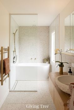 a bathroom with a tub, sink and mirror