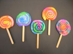 four lollipops with different colors on them