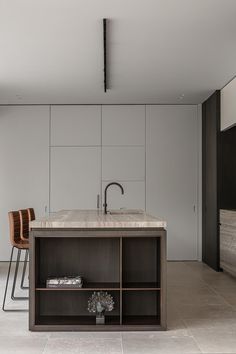 a kitchen with an island counter and two chairs