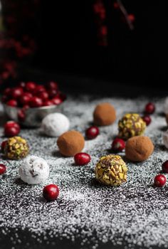 several different types of desserts on a table with powdered sugar and cranberries